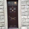 Dark wood composite door with rosewood frame and brass furniture, Ramsbottom.